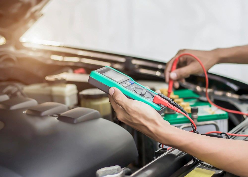 technician is checking car battery availability 1